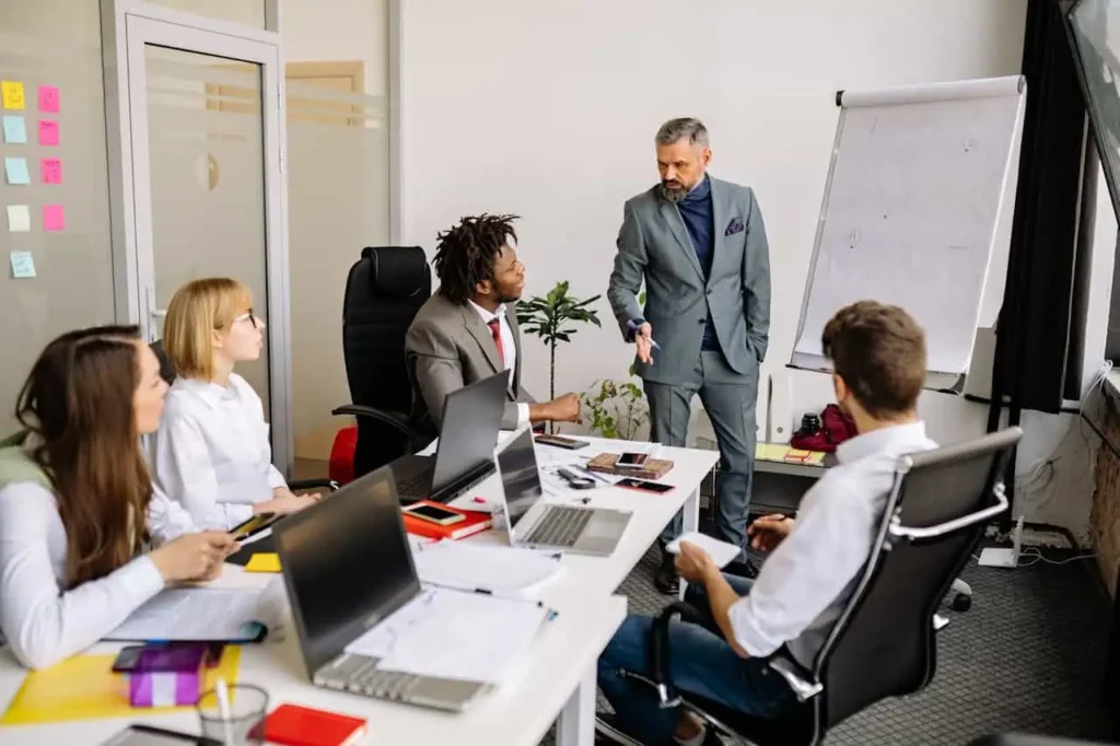man leading team meeting